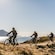 3 E bike riders cruising a rugged oceanfront path